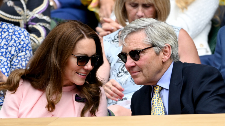 Kate and Michael Middleton speaking and seated