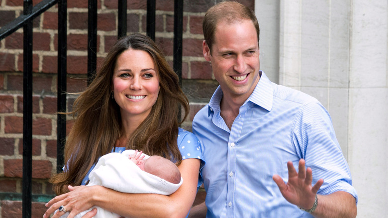 Kate Middleton and William posing with baby George