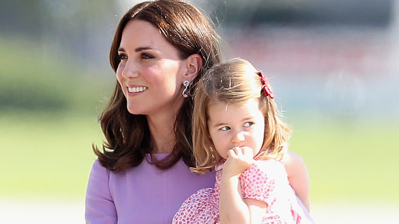 Kate Middleton holding young Charlotte 