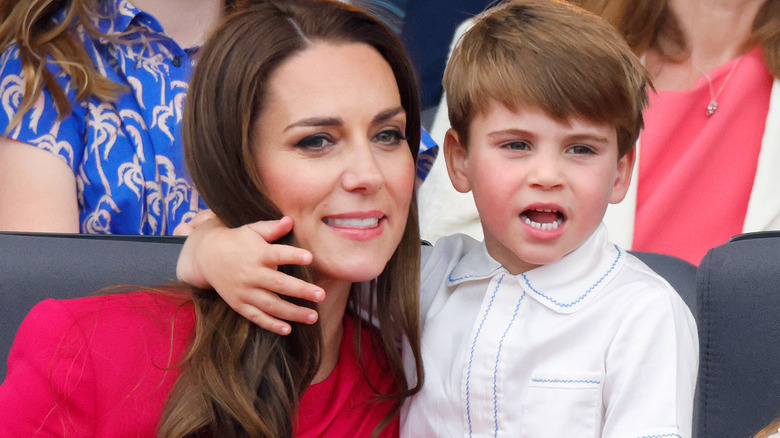 Prince Louis with his arm around Princess Catherine