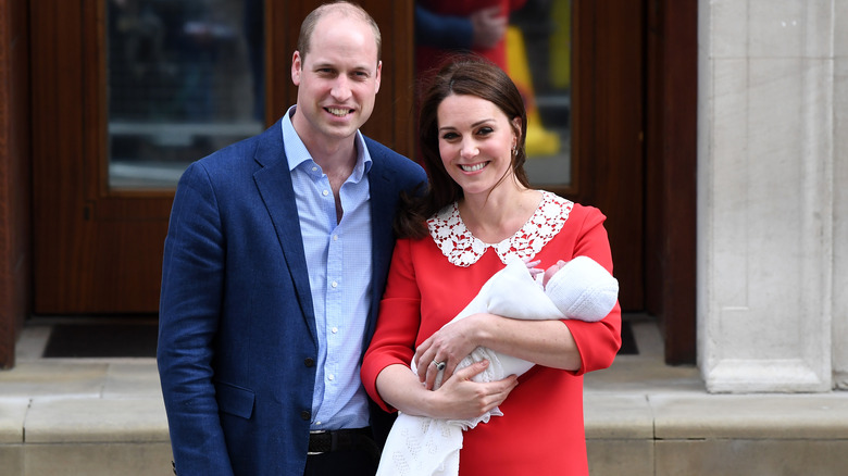 Princess Catherine and Prince William holding Baby Louis 