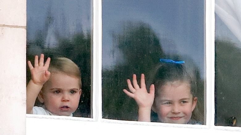 Prince Louis and Princess Charlotte waving from window
