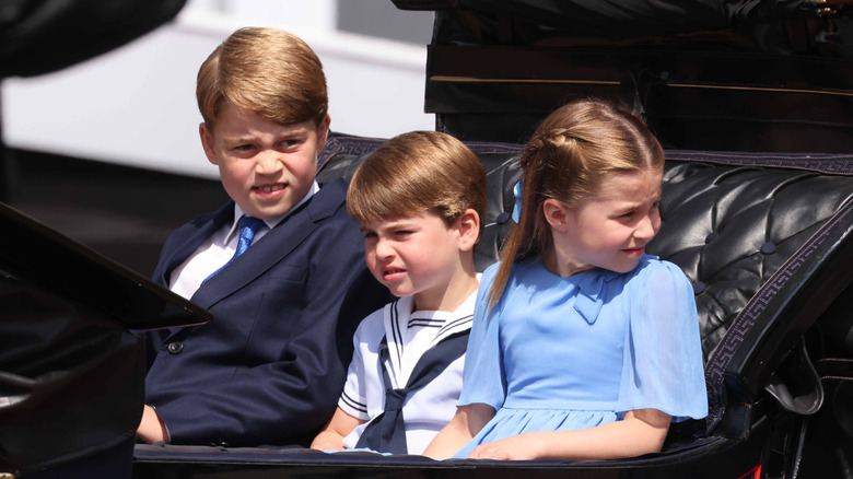 Prince George, Prince Louis, and Princess Charlotte in a carriage 