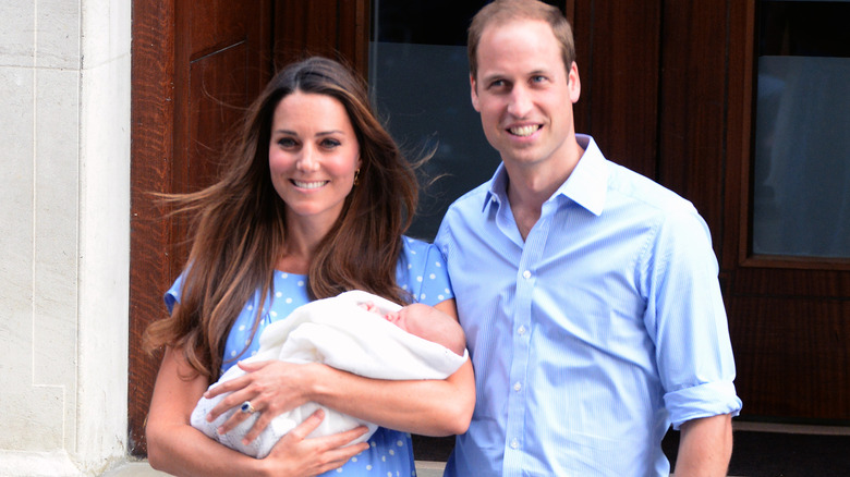 Prince William and Catherine holding George at hospital