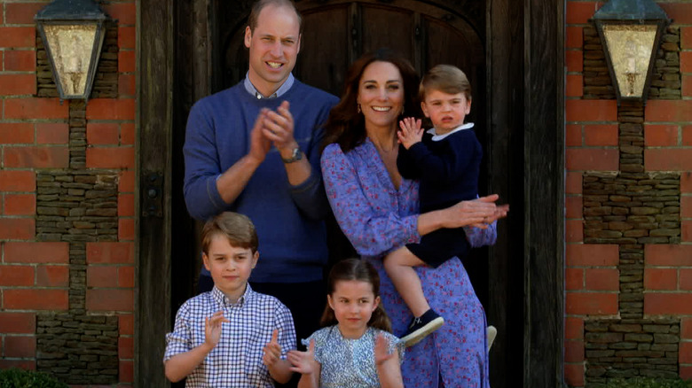 Prince William, Catherine, and family clapping at front door