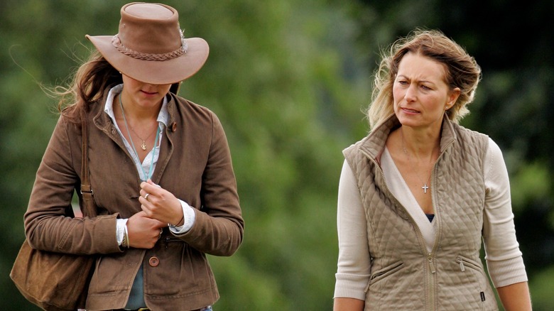 Princess Catherine and Carole Middleton walking together wearing brown