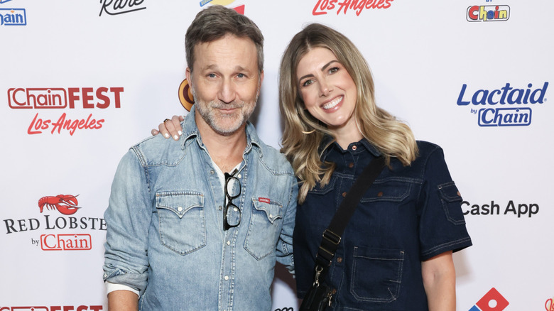 Breckin Meyer and Kelly Rizzo smiling while posing at an event