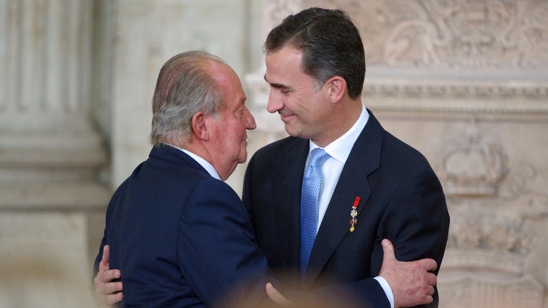 Juan Carlos I and King Felipe embrace in 2014