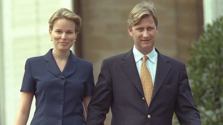 Young Queen Mathilde and King Philippe walking