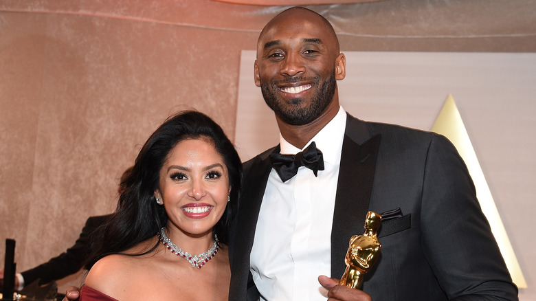 Kobe Bryant holding an award with Vanessa