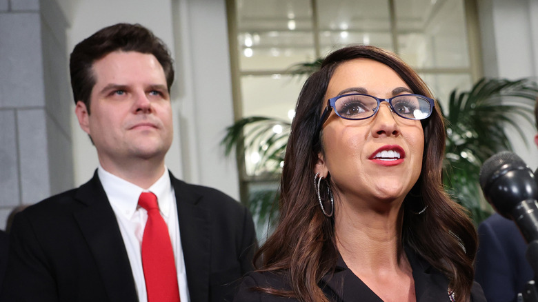 Lauren Boebert speaking with Matt Gaetz standing beind her.