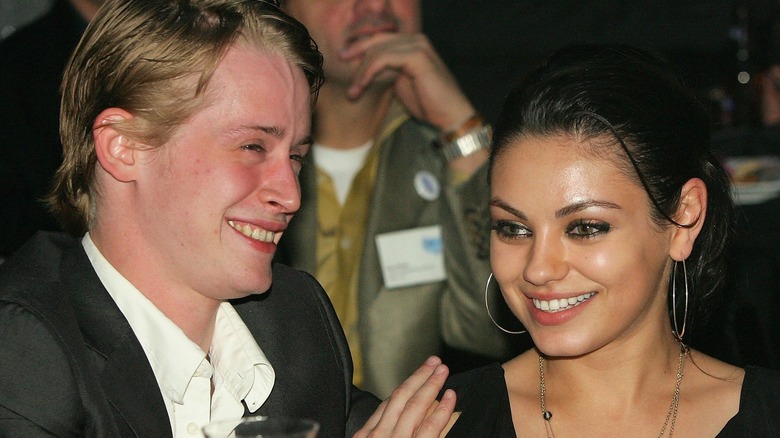 Macaulay Culkin and Mila Kunis laughing