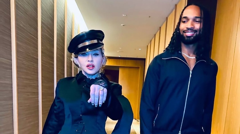 Madonna showing off ring and walking with Akeem Morris