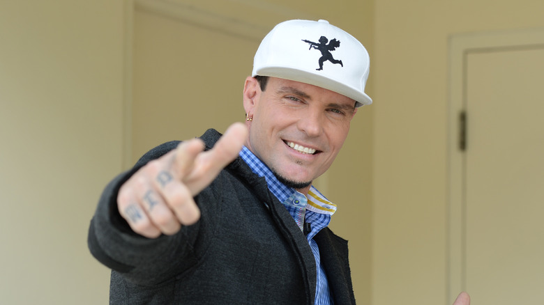 Vanilla Ice pointing at camera smiling