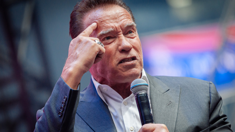 Arnold Schwarzenegger speaking into a microphone