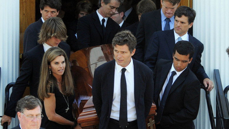 Maria Shriver, brothers carrying a casket