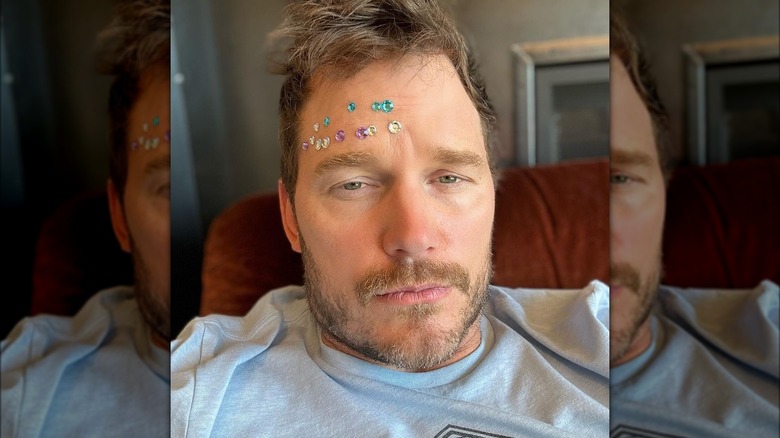 Chris Pratt with stickers on face in a selfie