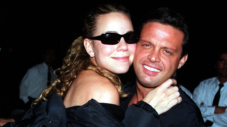 Mariah hugging Luis Miguel at a restaurant