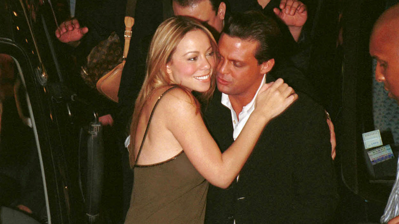 Mariah Carey holding Luis Miguel at Tango club