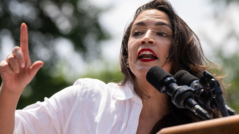 Alexandria Ocasio-Cortez passionately delivering a speech with finger raised