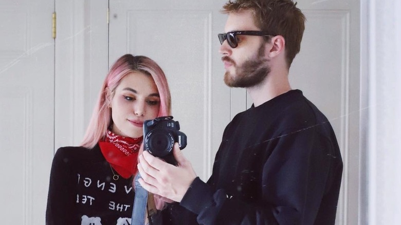 Marzia and PewDiePie standing in front of mirror