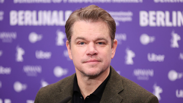 Matt Damon looks at the camera against Berilnale backdrop