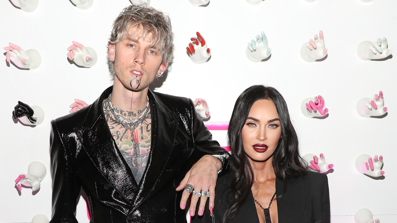 Megan Fox and Machine Gun Kelly posing at a red carpet event