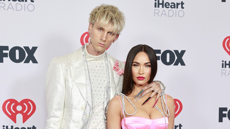 MGK, hand on Megan Fox's shoulder