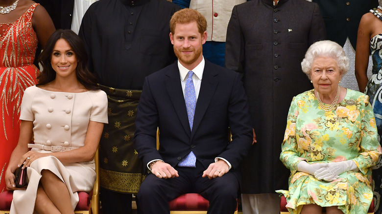 Meghan Markle, Prince Harry and Queen Elizabeth posing