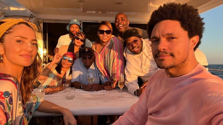 Minka Kelly and Trevor Noah take a selfie with friends