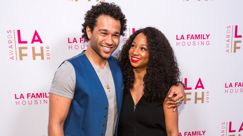 Corbin Bleu and Monique Coleman posing together at an event