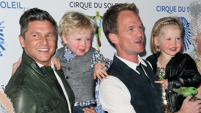 Neil Patrick Harris, David Burtka, Harper, and Gideon at an event