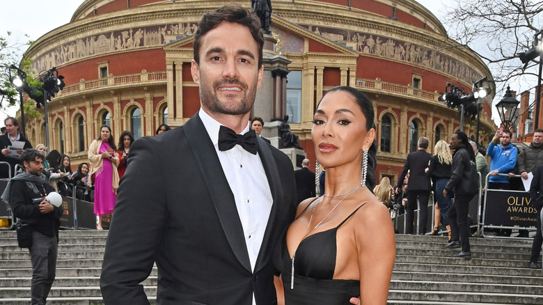 Nicole Scherzinger posing for photos with Thom Evans