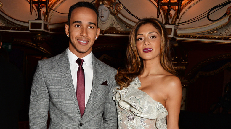 Nicole Scherzinger posing for photos with Lewis Hamilton