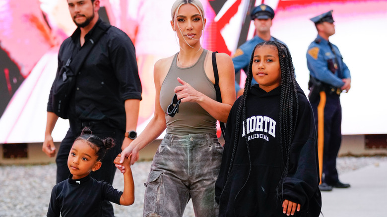 Kim Kardashian walking with North West and Chicago West