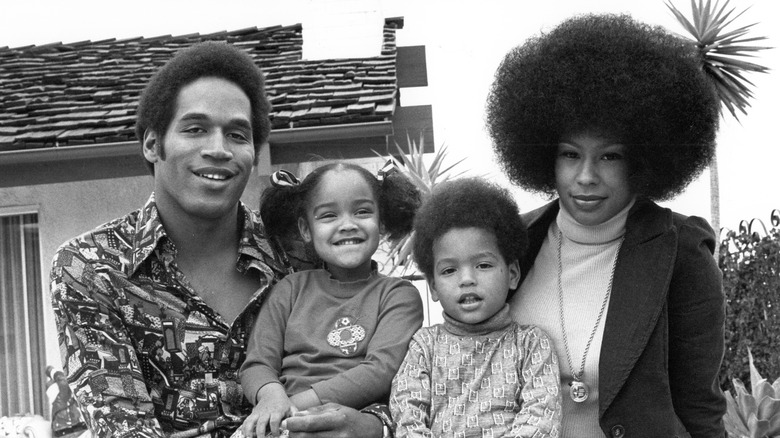 O.J. Simpson and Marguerite L. Whitley posing with Jason and Arnelle