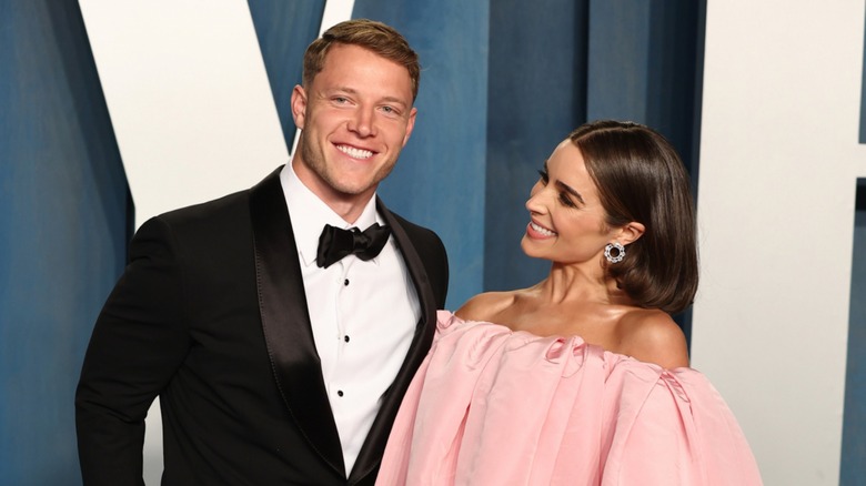 Olivia Culpo wearing pink gown with Christian McCaffrey 