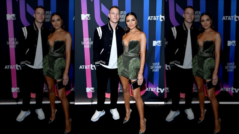 Oliva Culpo and Christian McCaffrey posing at MTV event