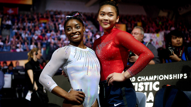 Simone Biles and Suni Lee posing together