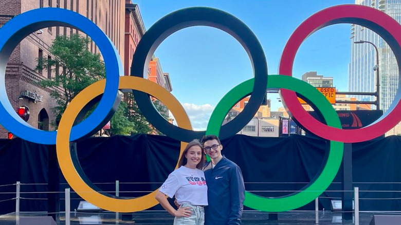 Tess McCracken and Stephen Nedoroscik posing in front of olympic rings