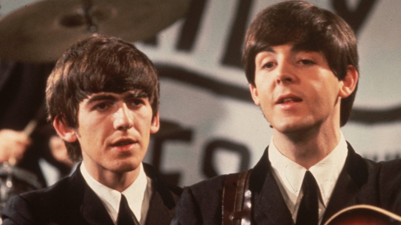 Young George Harrison and Paul McCartney on stage