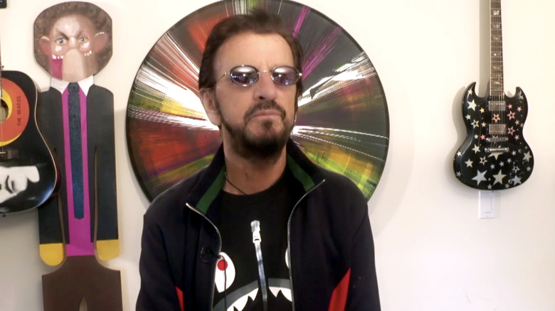 Ringo Starr in front of guitars