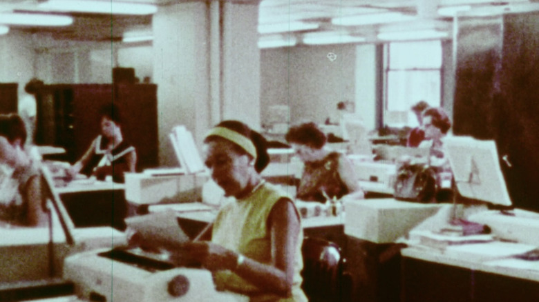 Room of secretaries typing