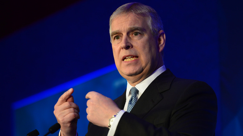 Prince Andrew speaking and gesturing with his fingers in different directions