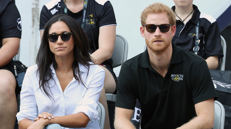 Meghan Markle and Prince Harry watching