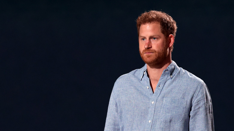 Prince Harry looking serious in light blue shirt