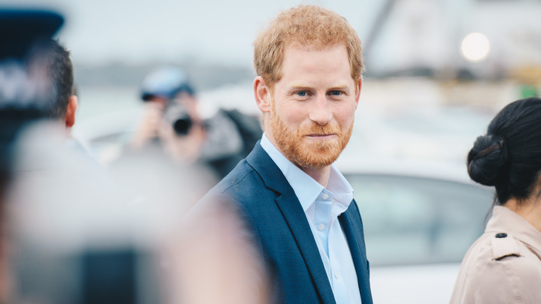 Prince Harry walking through paparazzi