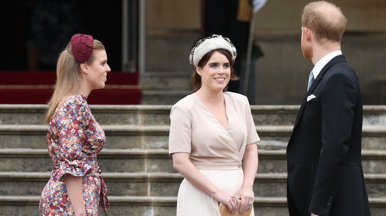 Prince Harry, Princess Eugenie, and Princess Beatrice talking