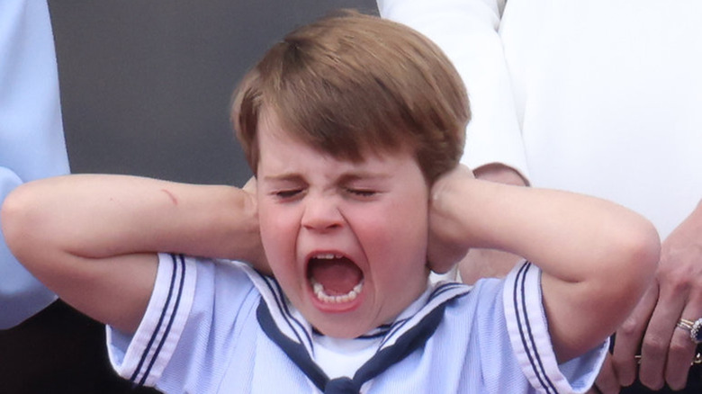 Prince Louis covering his ears screaming 