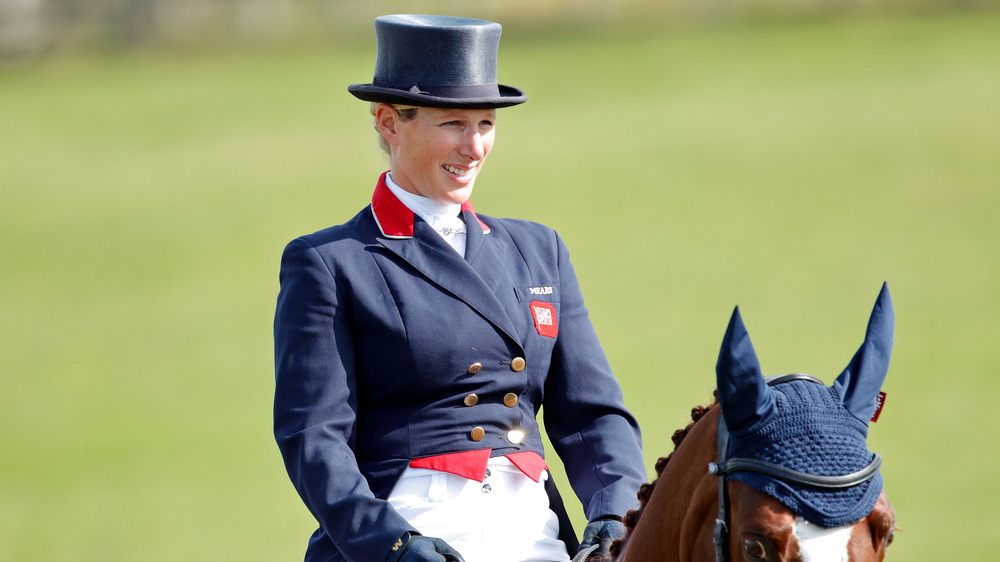 Zara Phillips smiling while riding a horse.